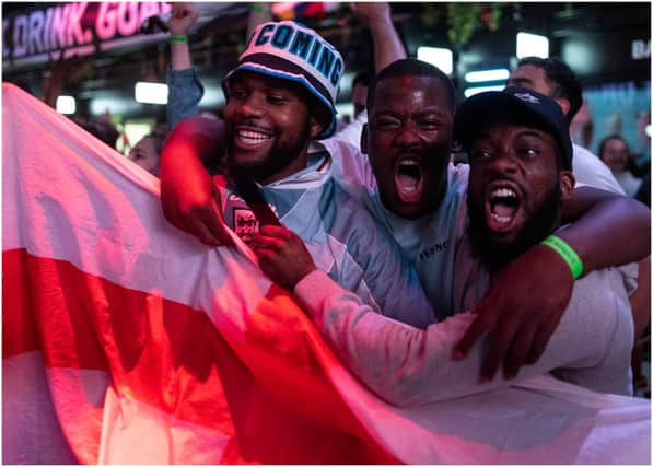 England fans cheer as they watch a live broadcast of the semi-final match between England and Denmark  (Getty Images)
