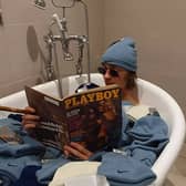 Depop entrepreneur Callum Massey poses in a bath full of deadstock nike beanies from 2002 that he purchased and resold on the site. 