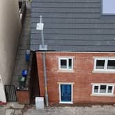 A builder in Ashton-under-Lyne built a house around a lamppost rather than wait for it to be moved. It will be moved at a later date 