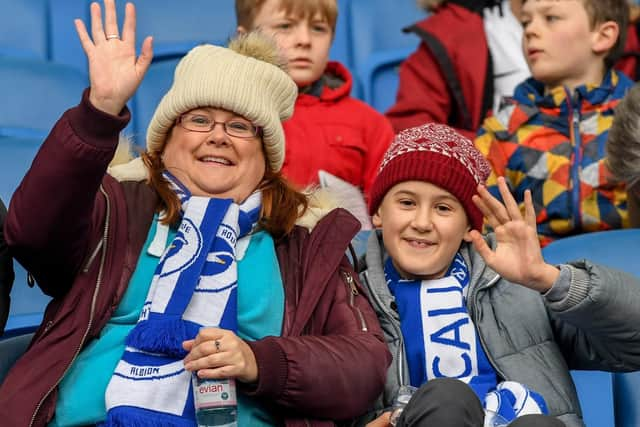 Albion fans wave to the camera before kick-off