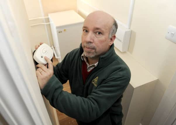 Malcolm Farrow of OFTEC checks his carbon monoxide detector