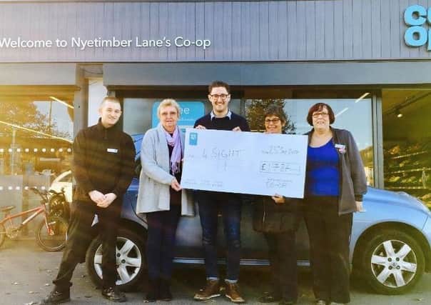 Co-op Nyetimber Lane manager Daniel Hibbs, centre, presents the cheque to volunteer Margaret Russell and trustee Maureen Jenkins from 4Sight Vision Support, watched by store assistants Luke and Dawn