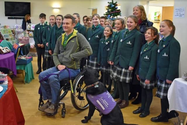 Conifers School Senior Choir with trustee Jon Flint and canine partner Jester