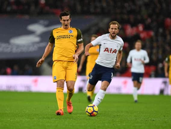 Lewis Dunk on the ball under pressure from Harry Kane. Picture by Phil Westlake (PW Sporting Photography)