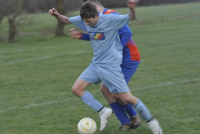 AFC Hollington and Battle Baptists thirds tussle for possession.