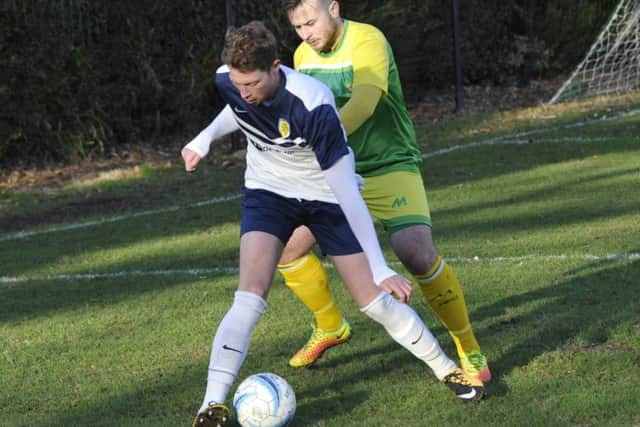 Westfield joint manager Jack Stapley pressurises an Upper Beeding opponent.