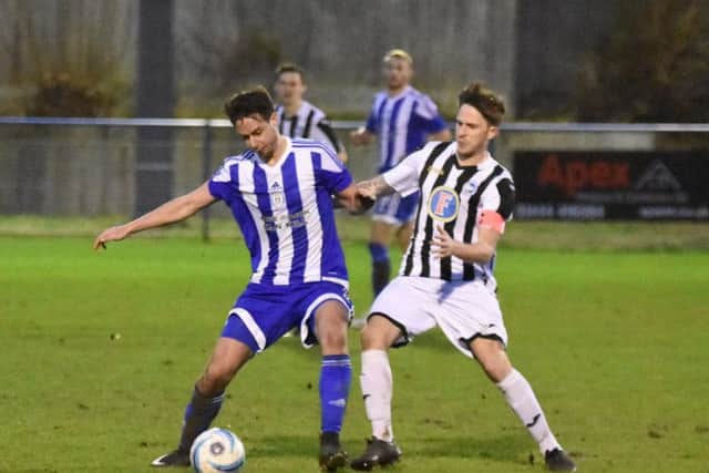 Jamie Weston holds the ball up. Haywards Heath Town v Peacehaven. Picture by Grahame Lehkyj