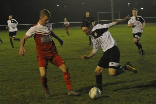 Bexhill United wing-back Luke Woodley tries to take on a Seaford opponent.