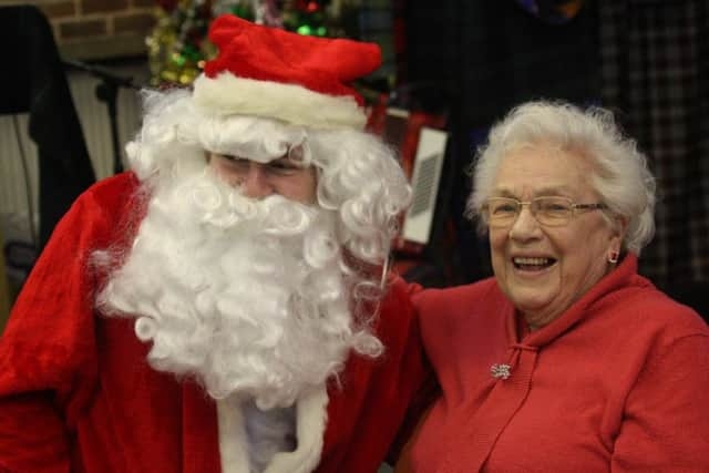 New Life Church in Durrington hosted a Christmas Lunch for around 70 people who would otherwise spend it alone. Pictured: one of the guests with Father Christmas. Picture: Jamie Peacock