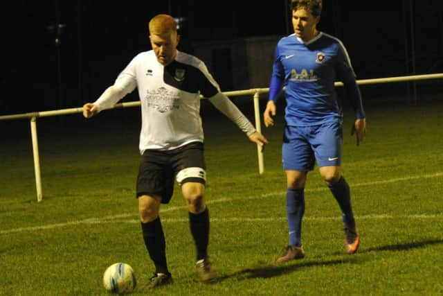 Zack McEniry, scorer of Bexhill's match-winning penalty, holds the ball up.