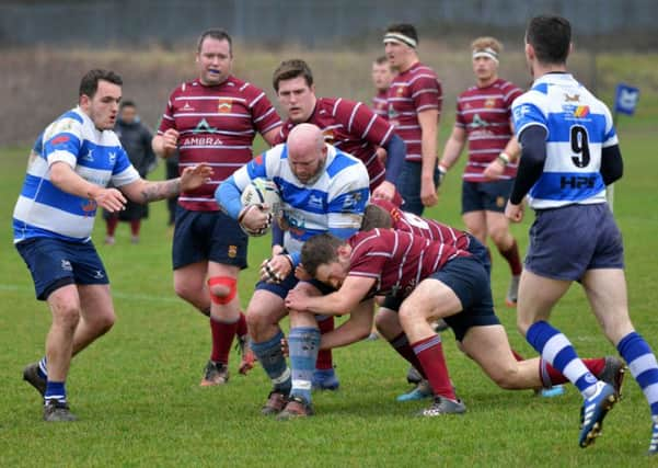 Hastings & Bexhill prop Steve McManus is tackled by two Crawley opponents. Pictures by Justin Lycett