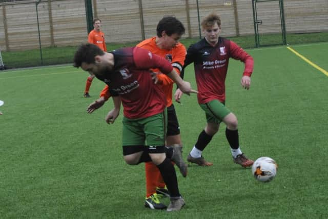 Orington and Burwash tussle for possession on the impressive new 3G pitch at Bexhill College.