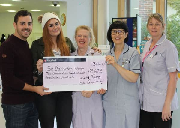 Jake Costin and Hannah Pheasant, left, present the cheque at St Barnabas House hospice