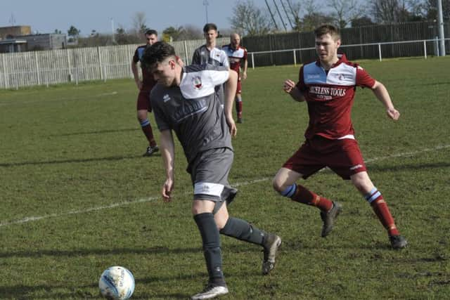 The fit-again Sam Winter keeps a close eye on the Wick player in possession.