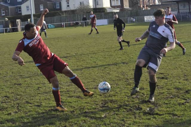 Wes Tate, scorer of Little Common's first goal, challenges Wick forward Josh Irish.