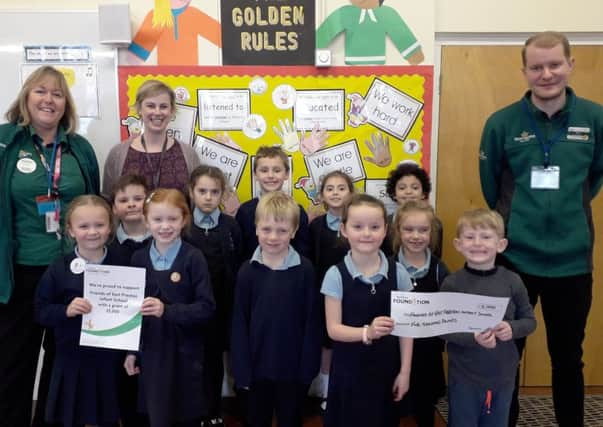 Alison Whitburn, community champion at Morrisons Littlehampton, left, and colleague Brad with members of the school council