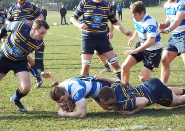 Hastings & Bexhill winger Tim Sills is brought to ground by a Thanet Wanderers opponent. Picture courtesy Peter Knight