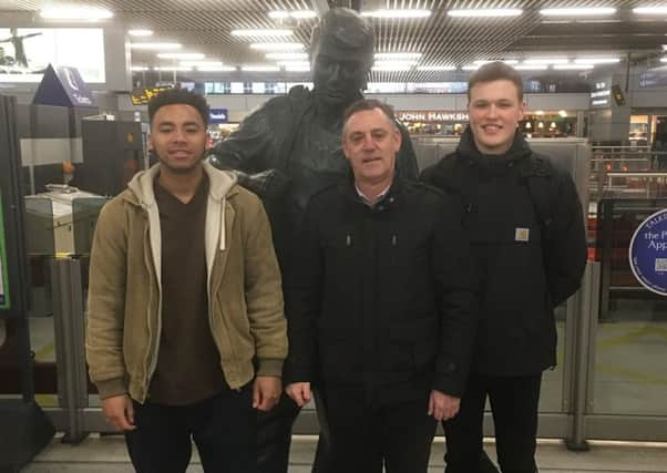 Luke Ellyatt, Theo Hines, and their teacher Kevin Smith at the Plumbers Apprentice statue