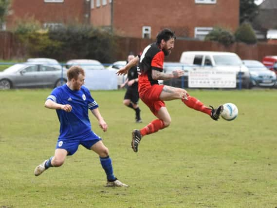 Spencer Slaughter jumps in to win the ball. Haywards Heath Town v Hassocks. Picture by Grahame Lehkyj