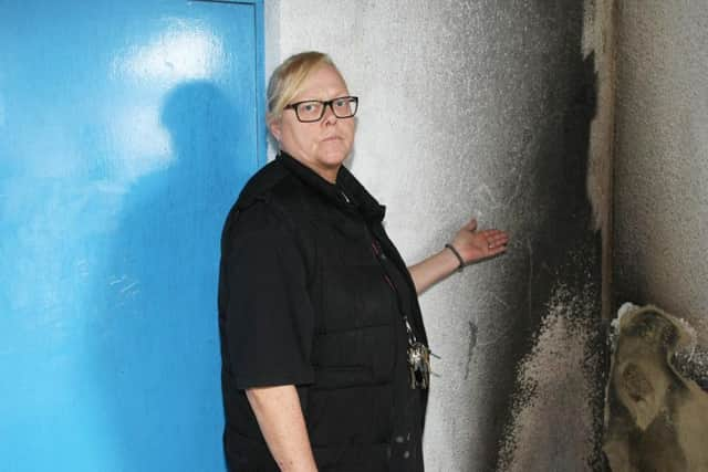 Annette Humphrey, club administrator, next to where the fire was started. Photo by Derek Martin Photography.