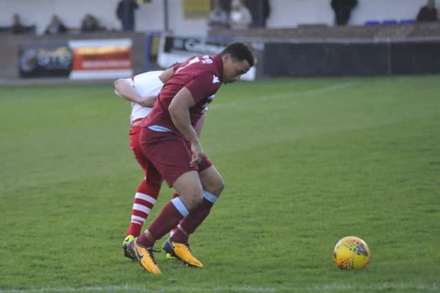 Wes Tate, scorer of Little Common's first two goals, holds off a Langney opponent.