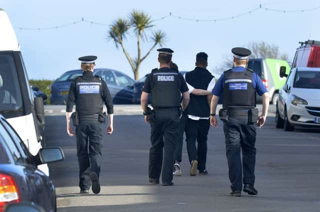 Police officers question people acting in an alleged antisocial manner in Eastbourne (Photo by Jon Rigby) SUS-181204-101324008