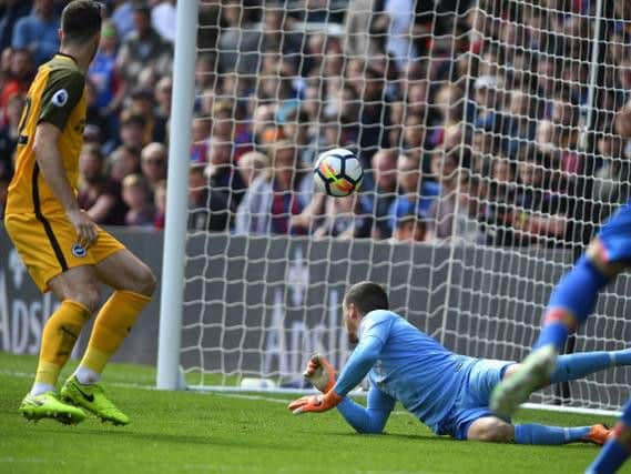 Wilfred Zaha has just tapped home Crystal Palace's opening goal as Shane Duffy and Maty Ryan watch on. Picture by PW Sporting Photography