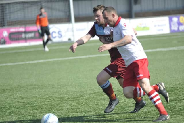 Common defender James Maynard tussles with Wilkinson.