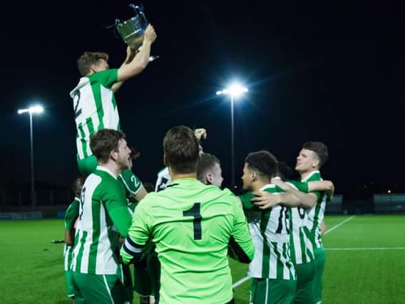 The City players get their hands on the cup / Picture by Tommy McMillan