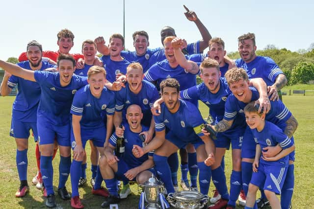 Heath players celebrate with both trophies. Picture by PW Sporting Photography