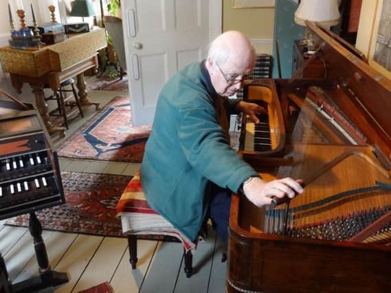 Nick Plumley tuning a square piano in in the Plumley collection in Arundel