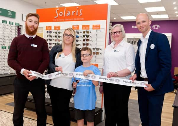 Eight-year-old Owen Bishop was on hand to cut the ribbon to mark the new Vision Express at Tesco Fishbourne Road store officially open