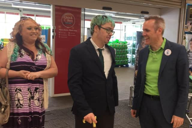 Tyler and Jan at Tesco Extra Chi meeting staff who are raising money