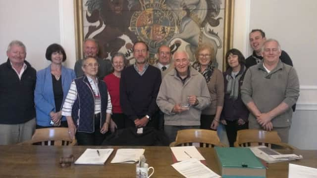 Ted Dummer centre with his tankard presented by fellow members of the council CONTRIBUTED PICTURE SUS-140528-104300001