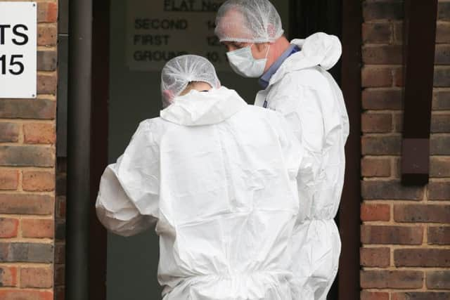 Forensics officers examining the scene of the incident