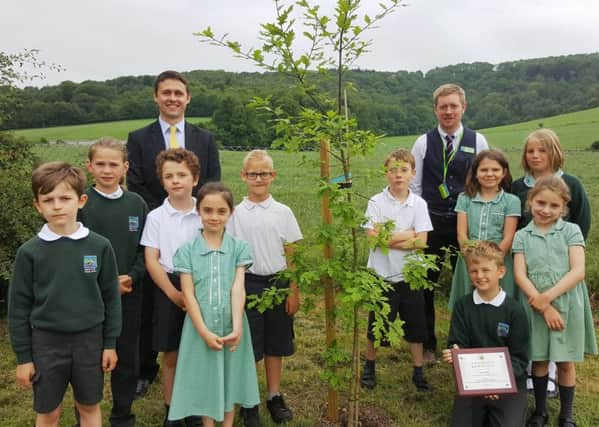 Head teacher Thomas Moore and senior associate solicitor Gareth Collins with pupils at Bury Primary School