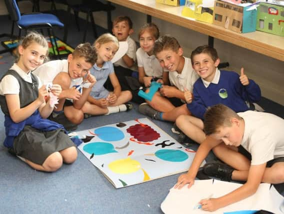 Steyning Primary School pupil cutting out shapes for their artwork. Picture: Derek Martin DM1864636a