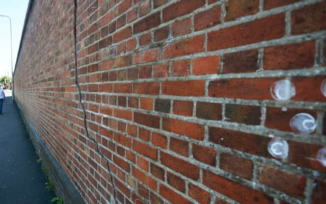 The wall with the large crack running down it in Station Road, Bexhill. SUS-180626-133105001