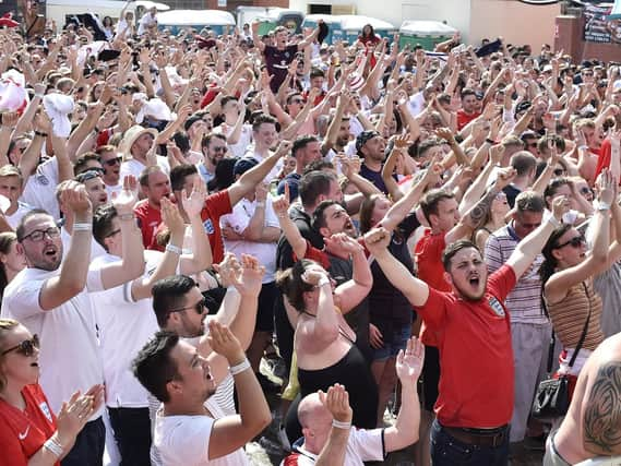 England fans celebrate Saturday's quarter-final win against Sweden.