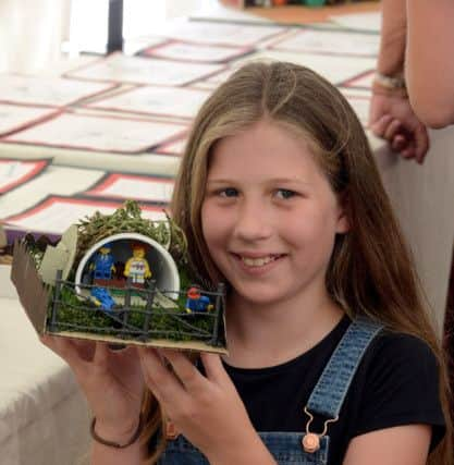 ks180335-4 Mundham Fete  phot kate
Sky Thomas, nine with her award winning air raid shelter..ks180335-4 SUS-180714-222143008