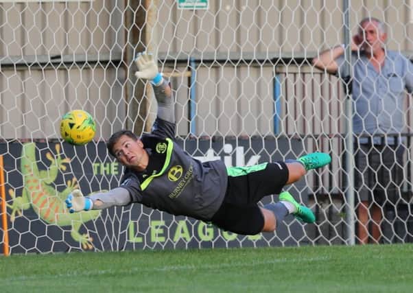 Hastings United goalkeeper Charlie Horlock makes a diving save against Lewes last night. Picture courtesy Scott White