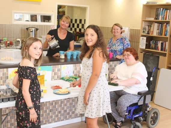 Volunteers Sarah Leeding, Adrienne Lowe and Rosie Denham with Jasmine Markwell, ten, and Chantelle Fenech, 12