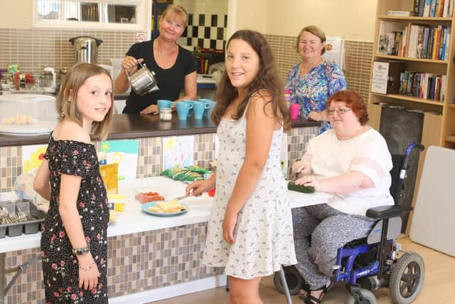 Volunteers Sarah Leeding, Adrienne Lowe and Rosie Denham with Jasmine Markwell, ten, and Chantelle Fenech, 12