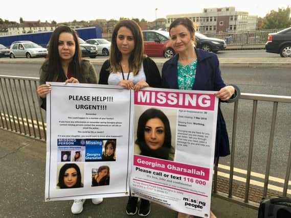 Sara, Arij and Andrea Gharsallah putting up posters on the Broadwater Bridge in Worthing