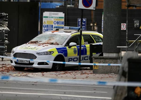 A police car covered in tiles (Photograph: Eddie Mitchell)