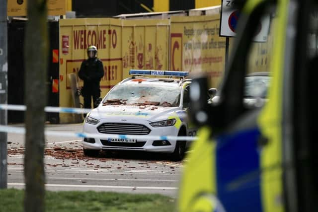 A police car covered in tiles (Photograph: Eddie Mitchell)