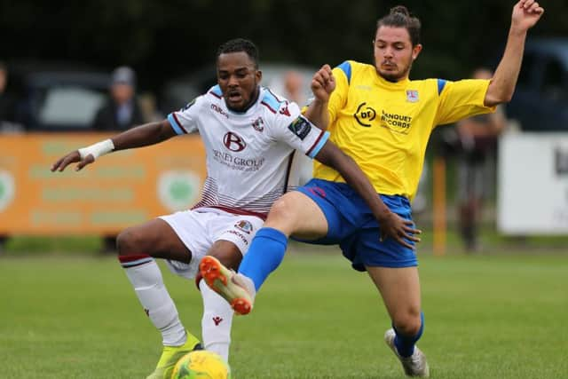 Kelvin Ogboe tries to hold off an opponent during Hastings United's 2-1 win at home to Kingstonian last weekend. Picture courtesy Scott White