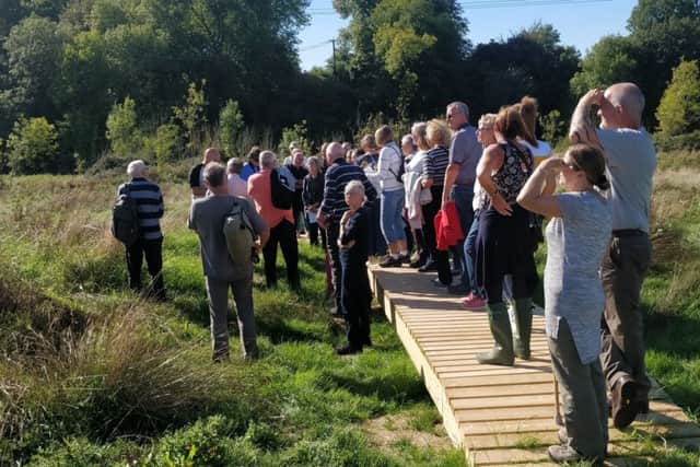 The Pastures New group enjoying a walk through Bramber Brooks , the new nature reserve