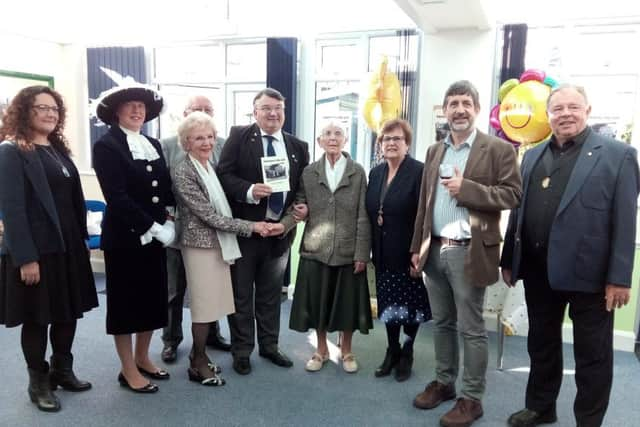 Sight Support Worthing president Bob Smytherman, centre, with the new book, Providing the Jam, and guests at the launch party