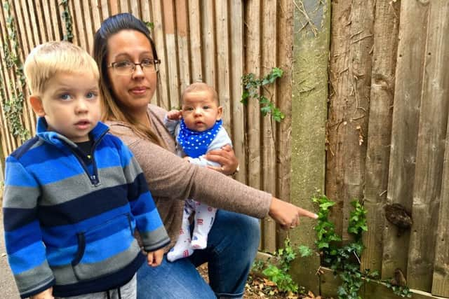 Leanne Balchin with her son Zachary, three, and Flynn, 17 weeks, in an alleyway off of Whiteways Close, Littlehampton, which has dog poo smeared on the fences.